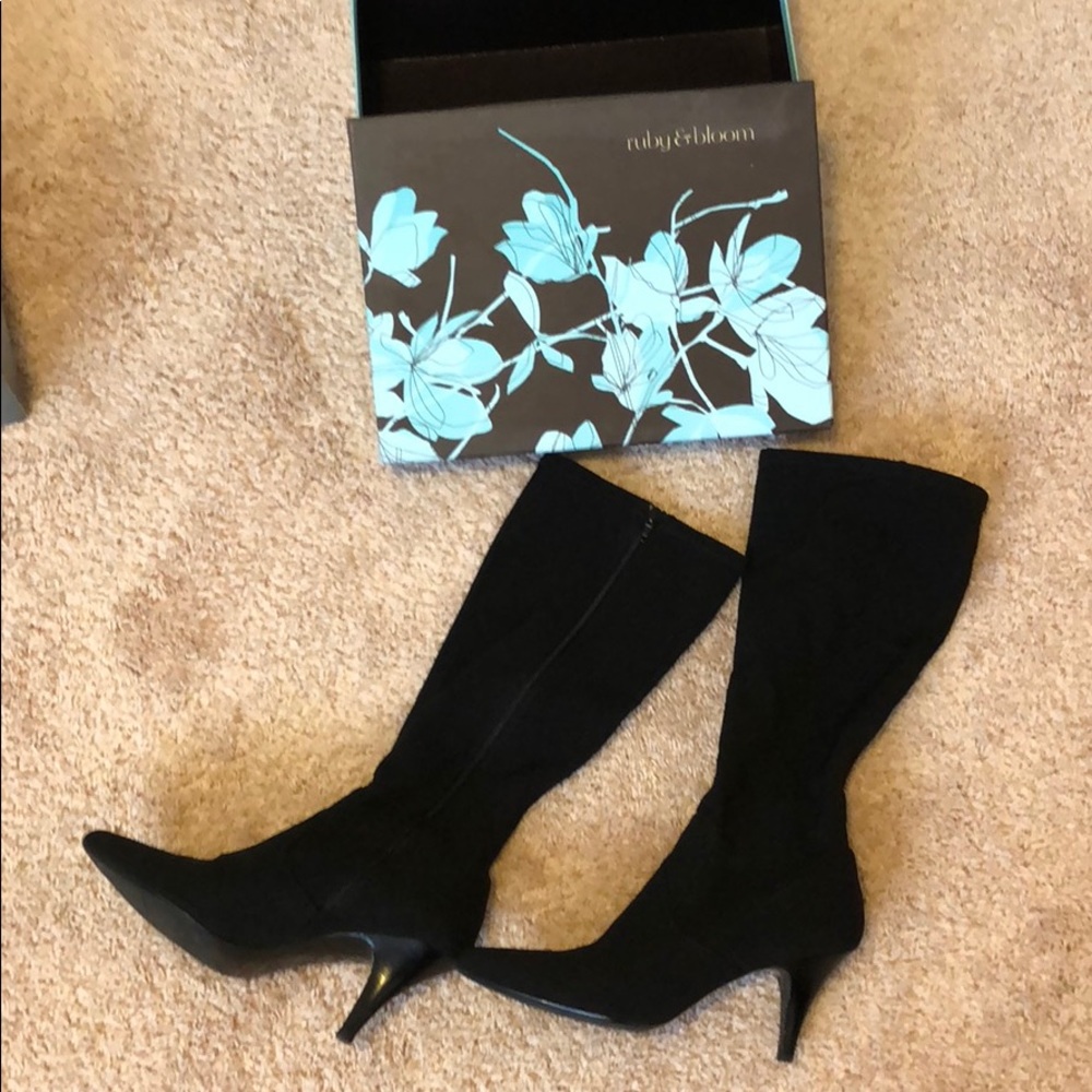 Black stretch fabric boots with 3 inch heel.